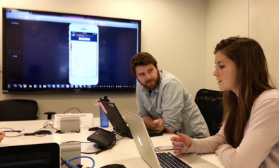 Two people are featured in an office setting, conducting a usability test.