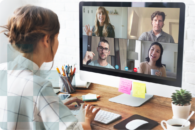 a person sitting by the desk on the video call with 4 people