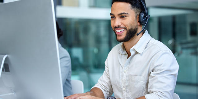 Person using the computer happily.