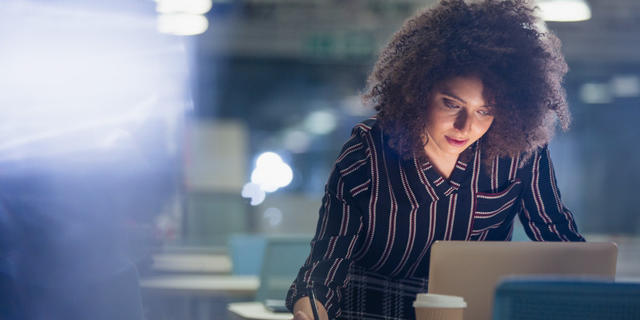 Woman studying in front of computer. 